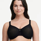 Model wearing Chantelle’s C Magnifique Moulded Bra in Black from The Foundation, featuring full-coverage cups and a smoothing mesh back band.