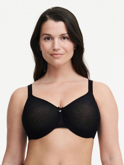 Model wearing Chantelle’s C Magnifique Moulded Bra in Black from The Foundation, featuring full-coverage cups and a smoothing mesh back band.