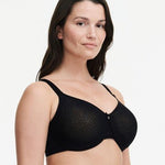 Model wearing Chantelle’s C Magnifique Moulded Bra in Black from The Foundation, featuring full-coverage cups and a smoothing mesh back band. side view