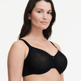 Model wearing Chantelle’s C Magnifique Moulded Bra in Black from The Foundation, featuring full-coverage cups and a smoothing mesh back band. side view