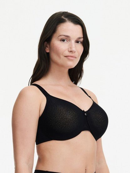 Model wearing Chantelle’s C Magnifique Moulded Bra in Black from The Foundation, featuring full-coverage cups and a smoothing mesh back band. side view
