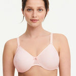 Model in Chantelle C Magnifique Moulded Bra in Rose from The Foundation, showcasing full-coverage cups and supportive smoothing mesh back.