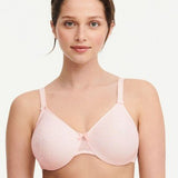 Model in Chantelle C Magnifique Moulded Bra in Rose from The Foundation, showcasing full-coverage cups and supportive smoothing mesh back.