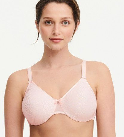 Model in Chantelle C Magnifique Moulded Bra in Rose from The Foundation, showcasing full-coverage cups and supportive smoothing mesh back.