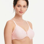 Model in Chantelle C Magnifique Moulded Bra in Rose from The Foundation, showcasing full-coverage cups and supportive smoothing mesh back.