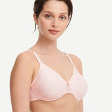Model in Chantelle C Magnifique Moulded Bra in Rose from The Foundation, showcasing full-coverage cups and supportive smoothing mesh back.