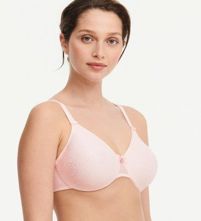Model in Chantelle C Magnifique Moulded Bra in Rose from The Foundation, showcasing full-coverage cups and supportive smoothing mesh back.