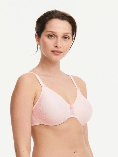 Model in Chantelle C Magnifique Moulded Bra in Rose from The Foundation, showcasing full-coverage cups and supportive smoothing mesh back.