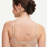Model in Chantelle C Magnifique Moulded Bra in Nude from The Foundation, featuring seamless full cups, minimising support, and soft mesh band. back view