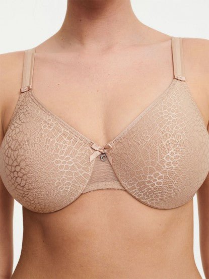 Model in Chantelle C Magnifique Moulded Bra in Nude from The Foundation, featuring seamless full cups, minimising support, and soft mesh band. close up view