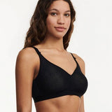 Side profile of C Magnifique Black wireless bra showing smooth silhouette and lightly padded adjustable straps.