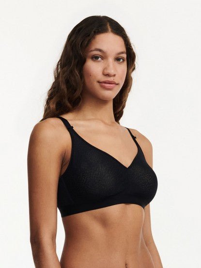 Side profile of C Magnifique Black wireless bra showing smooth silhouette and lightly padded adjustable straps.