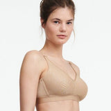 Side angle of  Chantelle C Magnifique wireless nude bra in a soft matte-shine floral knit, offering full bust support.