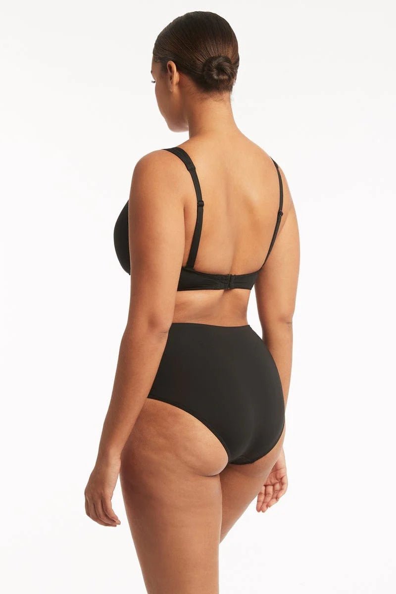 Sea Level Essentials Gathered Side High Waist Swim Pant in Black with ruched sides, high rise waist, and full bottom coverage, BACK VIEW – available at The Foundation