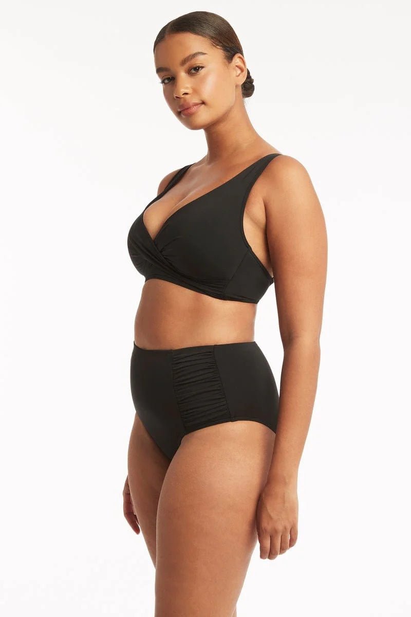 Sea Level Essentials Gathered Side High Waist Swim Pant in Black with ruched sides, high rise waist, and full bottom coverage – available at The Foundation