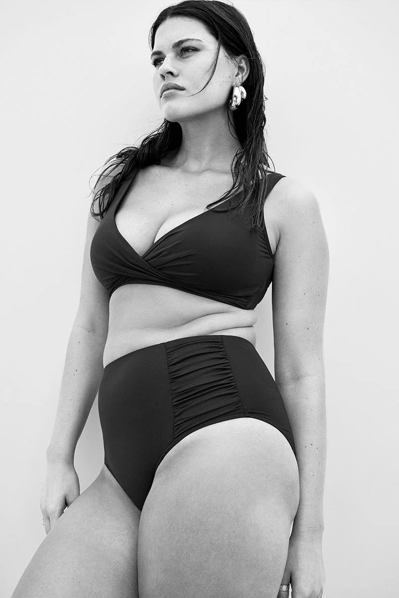 Sea Level Essentials Gathered Side High Waist Swim Pant in Black with ruched sides, high rise waist, and full bottom coverage – available at The Foundation