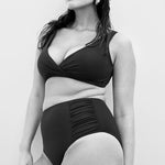 Sea Level Essentials Gathered Side High Waist Swim Pant in Black with ruched sides, high rise waist, and full bottom coverage – available at The Foundation