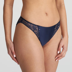 Side angle of Jane Rio Brief Velvet Blue from The Foundation, highlighting elegant blue lace, satin fabric, and pearl-detailed bows at the front