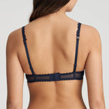 Back view featuring adjustable straps and hook closure, worn in standard style.