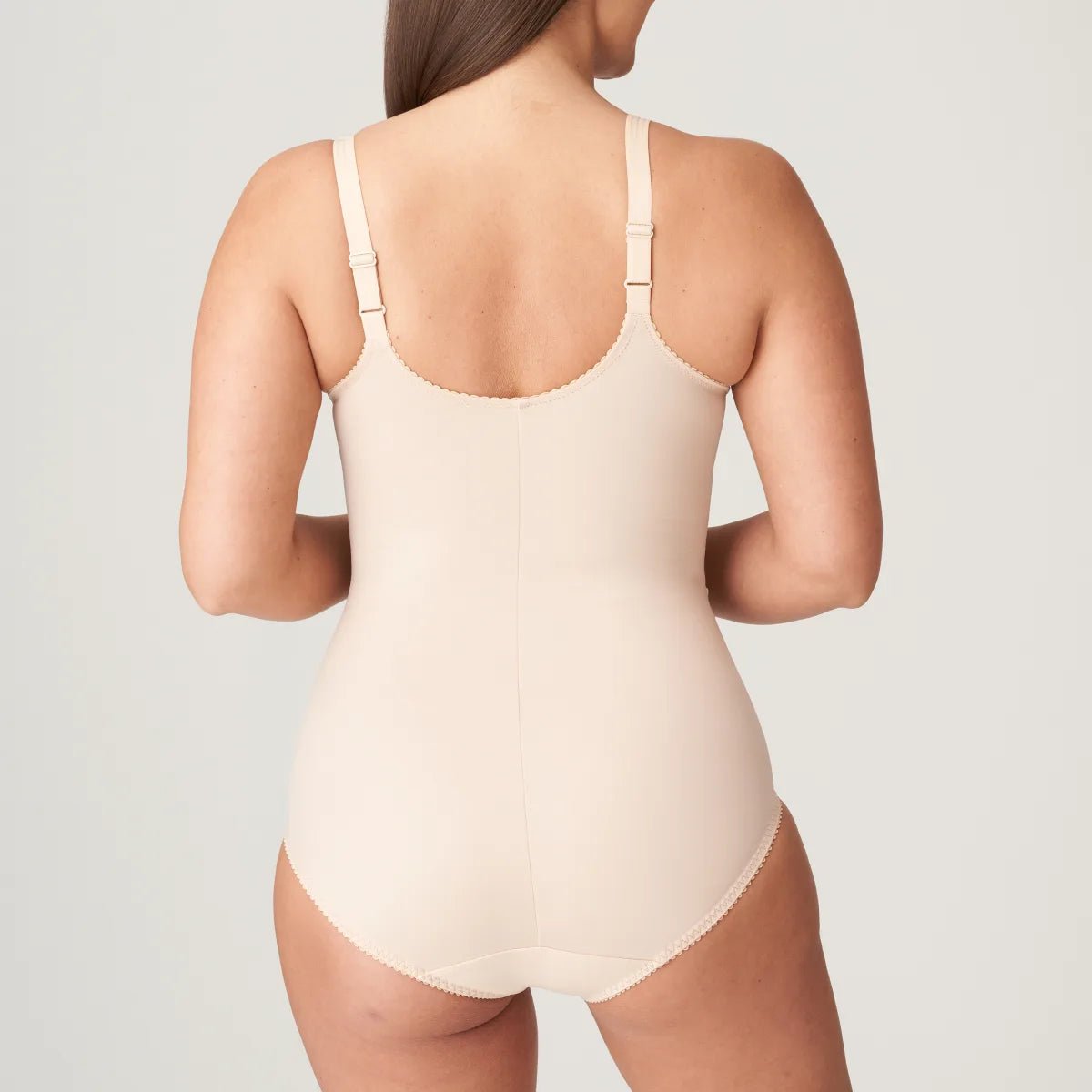 Back view of the PrimaDonna Deauville Bodysuit in Café Latte, showing adjustable straps and smoothing coverage, stocked at The Foundation.