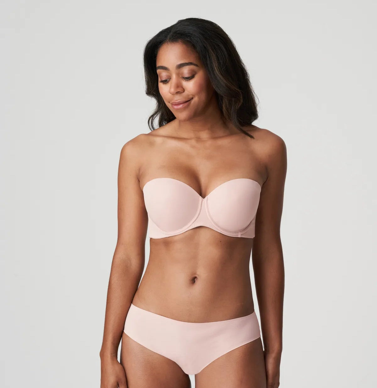 Model wearing Figuras Strapless Bra and brief set in Powder Rose – elegant and minimal full-body styling.