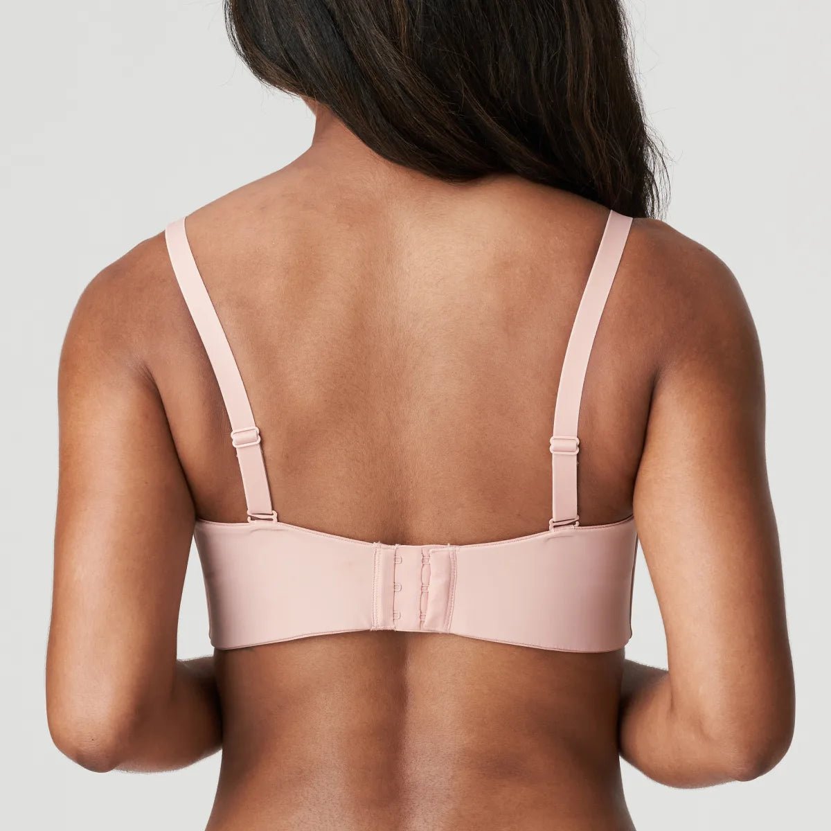 Back view of strapless bra showing secure band construction and smooth finish in Powder Rose.
