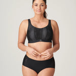 Model wearing The Game Sports Bra Black by PrimaDonna – full body shot showing supportive yet stylish activewear.