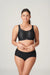 Model wearing The Game Sports Bra Black by PrimaDonna – full body shot showing supportive yet stylish activewear.