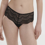 Model wearing Simone Pérèle Karma Shorty Brief in Black from The Foundation, mid-rise fit with scalloped lace and cheeky back design. front view