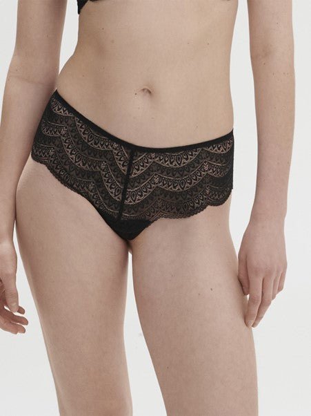 Model wearing Simone Pérèle Karma Shorty Brief in Black from The Foundation, mid-rise fit with scalloped lace and cheeky back design. front view
