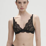 Model wearing Simone Pérèle Karma Wireless Triangle Bra in Black from The Foundation, with scalloped Italian lace and natural plunge neckline. front view