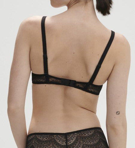 Model wearing Simone Pérèle Karma Wireless Triangle Bra in Black from The Foundation, with scalloped Italian lace and natural plunge neckline. back view