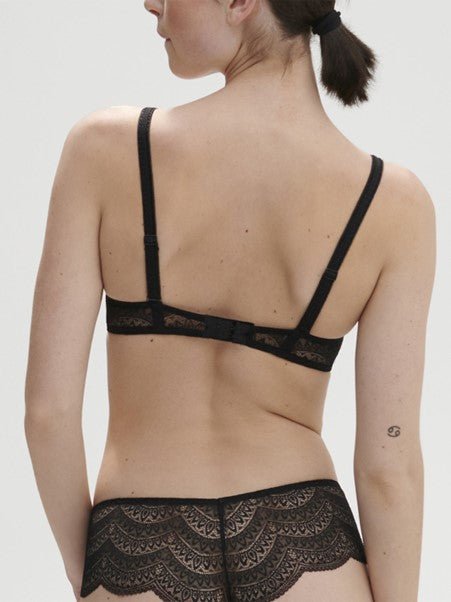Model wearing Simone Pérèle Karma Wireless Triangle Bra in Black from The Foundation, with scalloped Italian lace and natural plunge neckline. back view