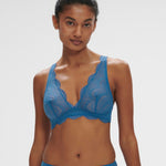 Model wearing the Simone Perele Karma Wireless Triangle Bra in vibrant Bleu Myosotis, featuring plunging neckline and scalloped lace detailing.