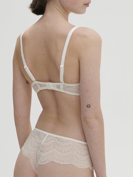 Model wearing Simone Pérèle Karma Wireless Triangle Bra in Natural from The Foundation, with scalloped jacquard lace and convertible back straps. back view