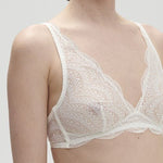 Model wearing Simone Pérèle Karma Wireless Triangle Bra in Natural from The Foundation, with scalloped jacquard lace and convertible back straps. close up