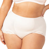Plus-size model wearing the Something Else Tum-E-Lace Full Brief in Fresh Powder by Triumph, showing high-waisted tummy control fit.