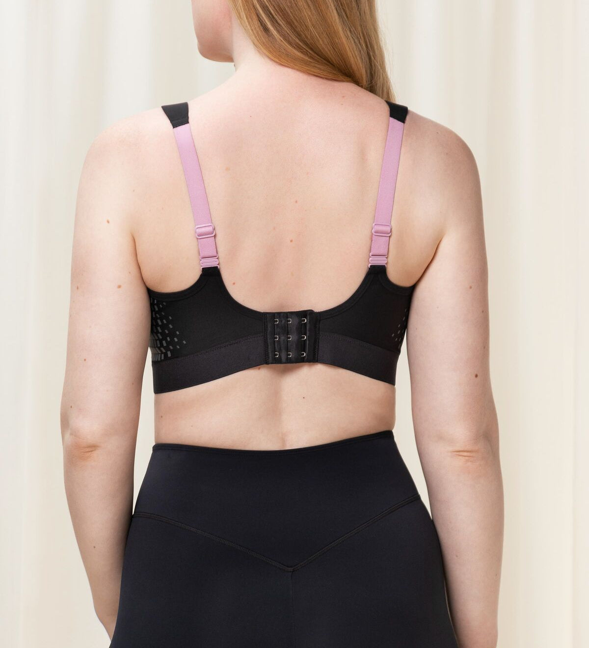 Back view of Triaction Control Lite Black sports bra, highlighting Dynamic Light® fabric and supportive design