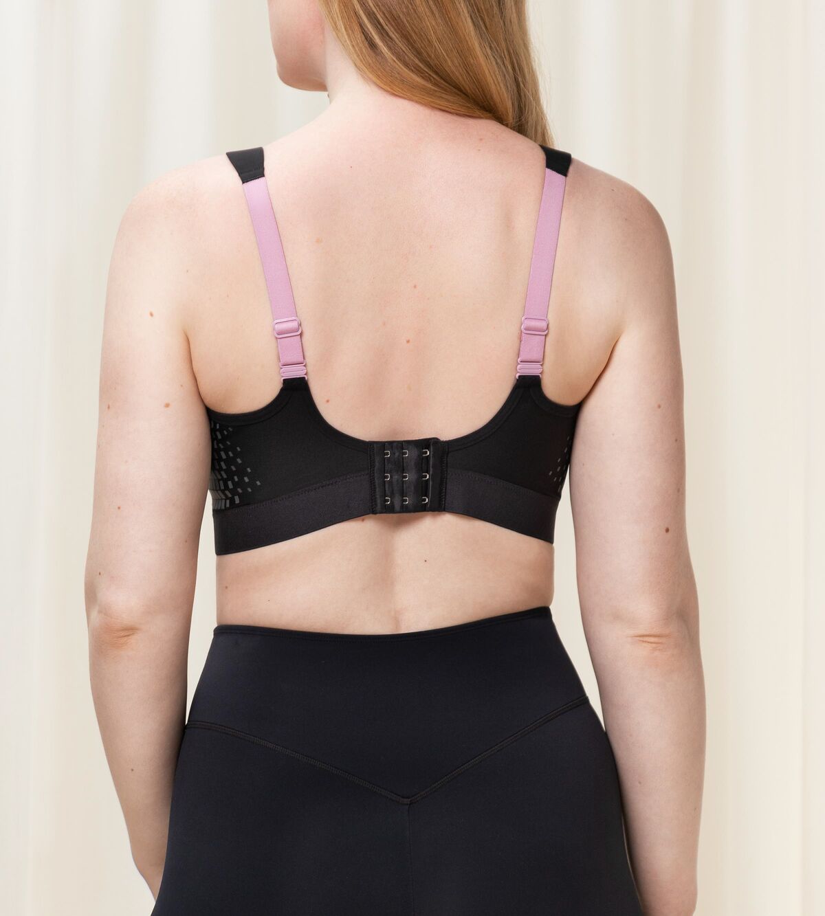 Back view of Triaction Control Lite Black sports bra, highlighting Dynamic Light® fabric and supportive design