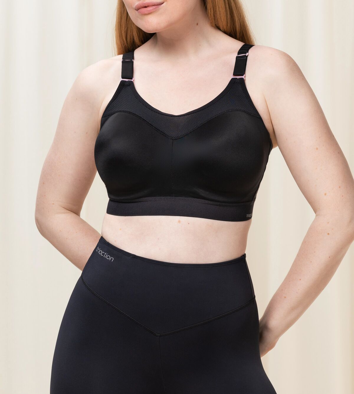 Front view of Triumph Triaction Control Lite Black sports bra from The Foundation, showing comfortable minimiser fit and wide straps