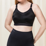 Front view of Triumph Triaction Control Lite Black sports bra from The Foundation, showing comfortable minimiser fit and wide straps