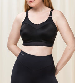 Front view of Triumph Triaction Control Lite Black sports bra from The Foundation, showing comfortable minimiser fit and wide straps