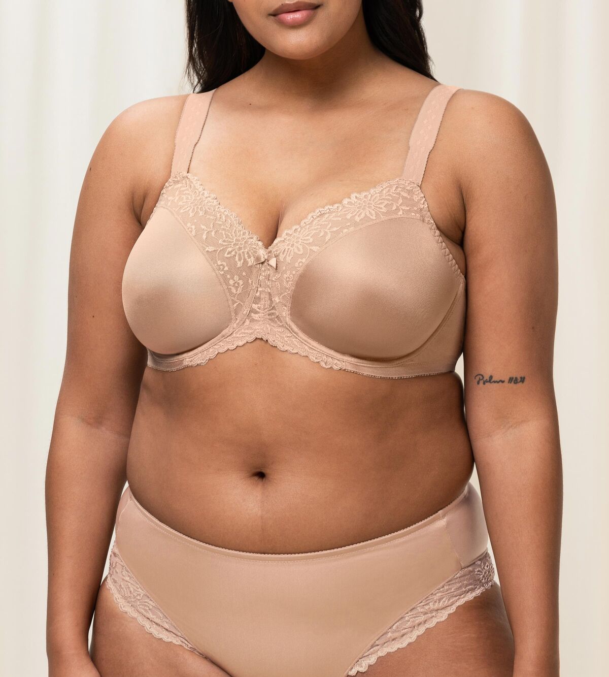Plus-size model wearing the Triumph Ladyform Soft WX Bra in Smooth Skin , showing supportive fit and comfortable lace design.