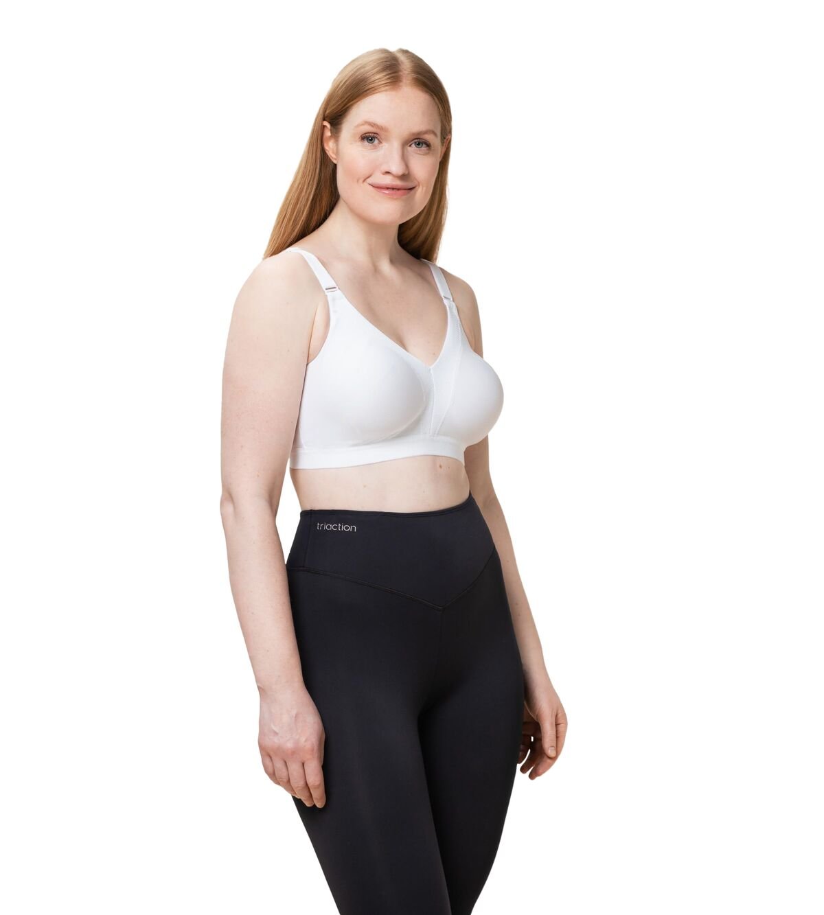 Model wearing full activewear set with Triaction Wellness Bra in White from Triumph—supportive and stylish from The Foundation.