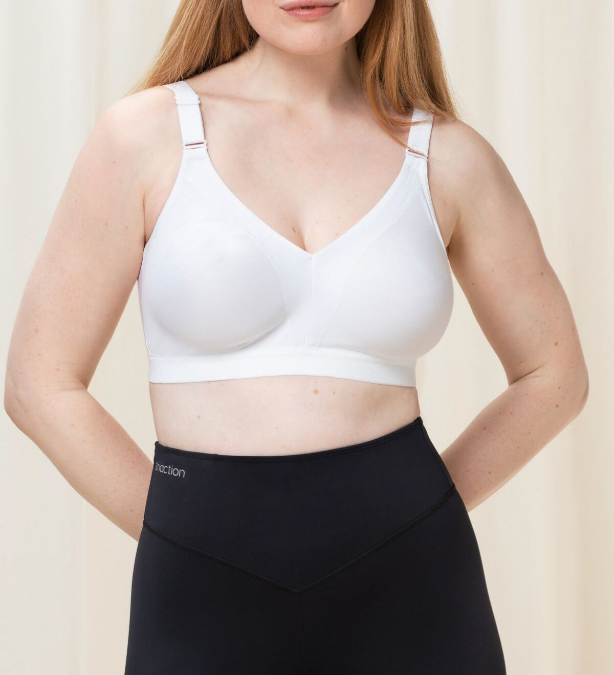 Front view of Triumph Triaction Wellness Bra in White, wire-free with mesh cups and wide straps—available at The Foundation.
