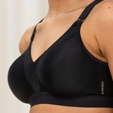 Close-up side profile of the Triaction Wellness Bra in Black by Triumph, with breathable mesh lining—shop now at The Foundation.