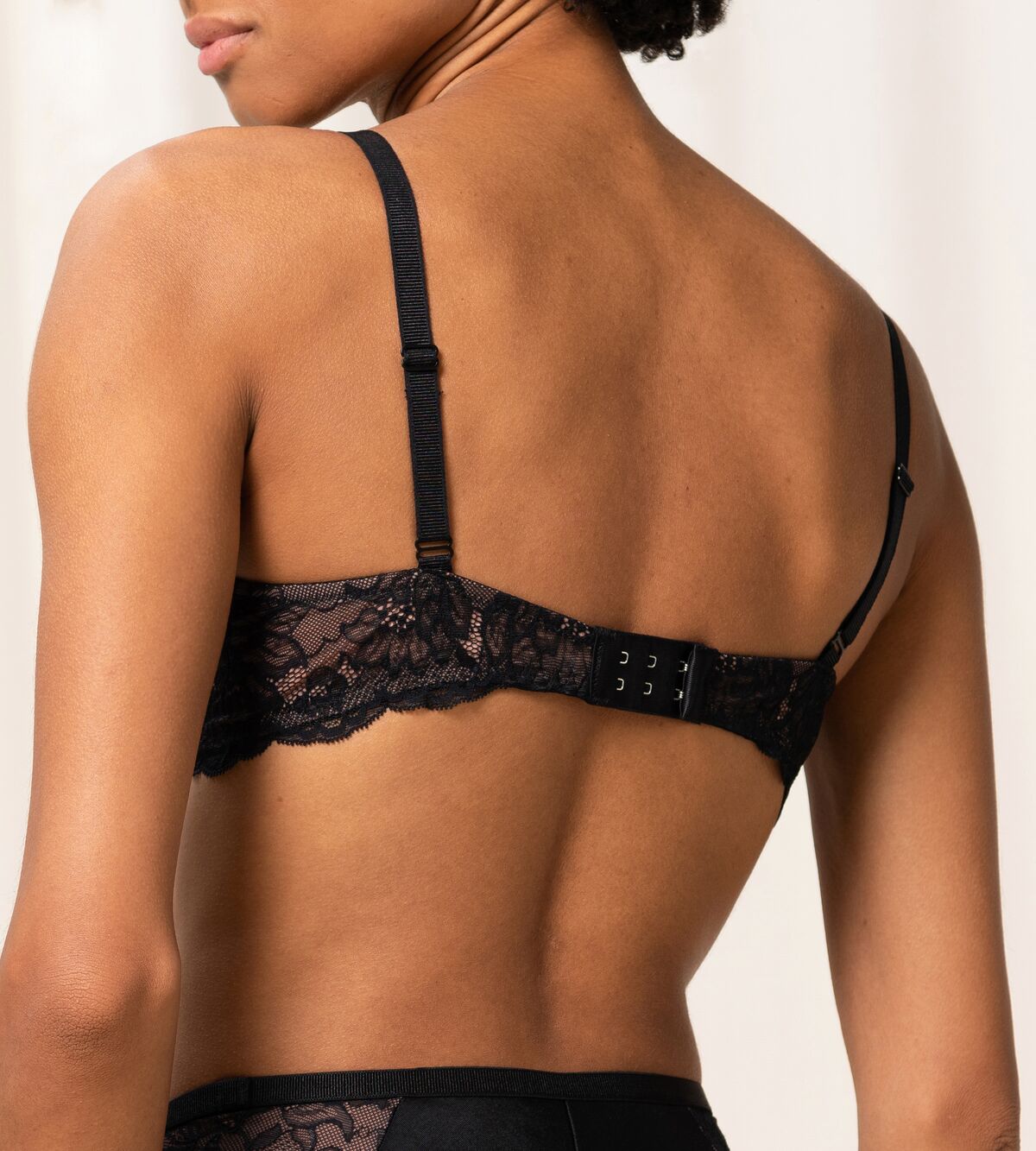 Back view of The Foundation's Amourette Charm Non Wire Bra in black, highlighting soft lace band and wirefree support.