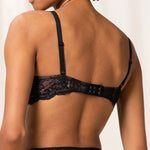 Back view of The Foundation's Amourette Charm Non Wire Bra in black, highlighting soft lace band and wirefree support.