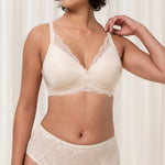Front view of The Foundation’s Amourette Charm Non Wire Bra in Creamy Dream, showing lace-trimmed cups and soft padded design.