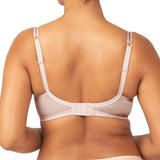 Back view of Triumph’s Sheer Minimiser Bra in nude pink, showing wide band and adjustable straps—available now at The Foundation.
